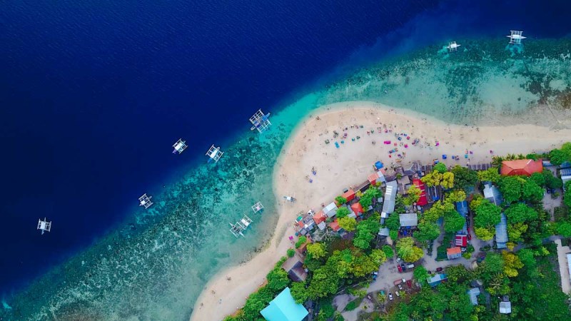 Cebu Aerial view of sandy beach with tourists swimming in beautiful c