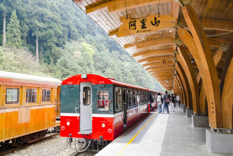 CHIAYI, Taiwan - Mar 10, 2012: Alishan National Scenic Area's railway station platform with passengers getting on to the train