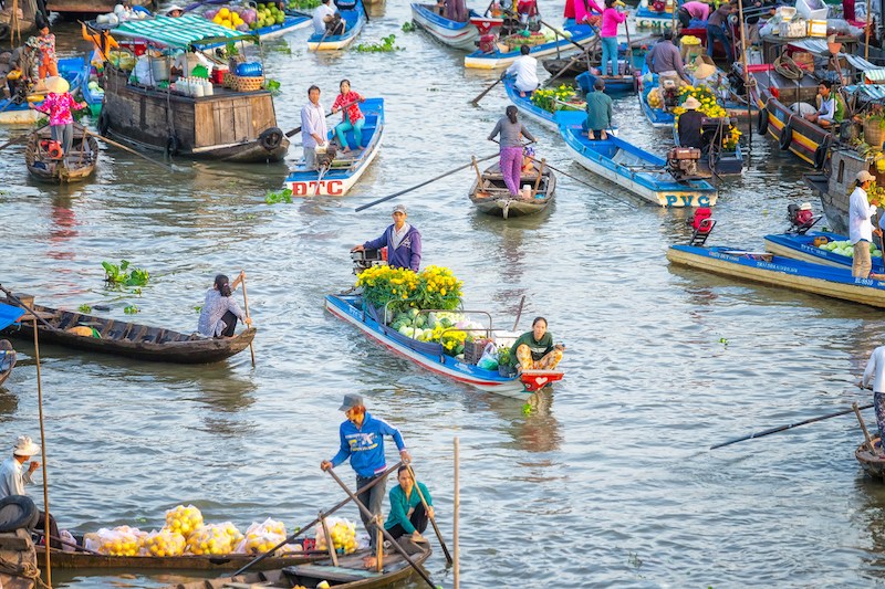 Spouses boatman selling daisies, watermelons on the river